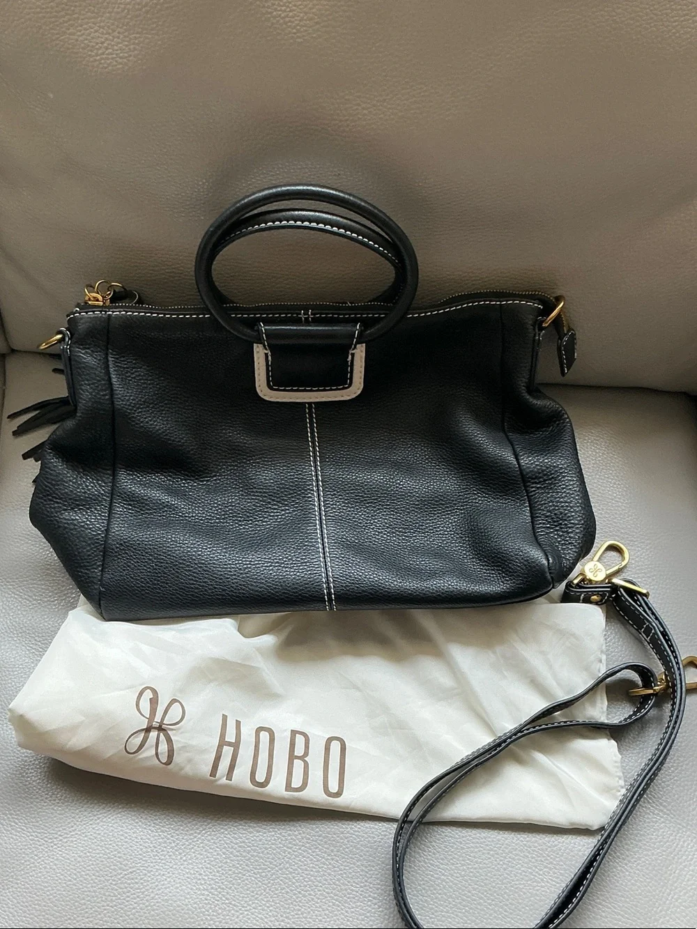 HOBO Sheila Black Pebbled Leather Top-Handle Hobo with Gold Hardware and tassel.